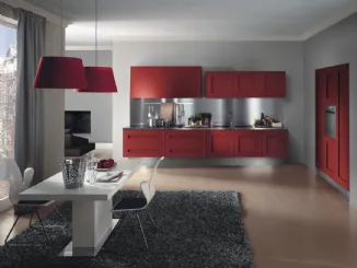 Cucina Design ad angolo sospesa Melograno in Rovere tinto Rosso con top in acciaio inox di Composit